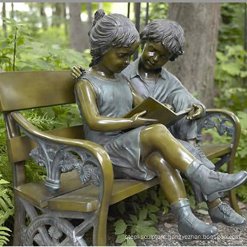 bronze boy and girl sitting on bench sculpture